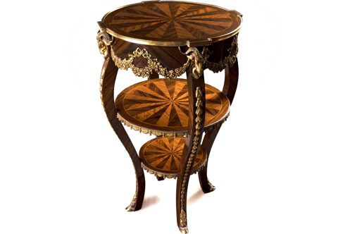 Magnificent French Regence Early Louis XV style ormolu-mounted two tiers Étagère, Professionally inlaid with sunburst veneer inlays and ornamented with aged gilt ormolu mounts of knotted ribbons issuing swaging blossoming garlands, The fine side table with two tiers decorated with rich ormolu draped garlands of molded tassels, Raised by cabriole supports are headed with regal exquisite ormolu ram heads, ornamented with ormolu laurel garlands and terminating with ormolu hoof feet